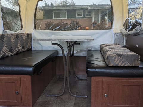 The pull out dinette has 3 large windows, sits four easily and allows for extra aisle room.