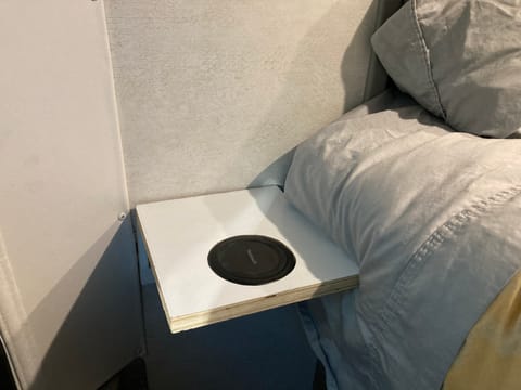 A fold down nightstand in the rear of the van give you a place to charge your phone overnight and keep a bottle of water or other nightly needs.