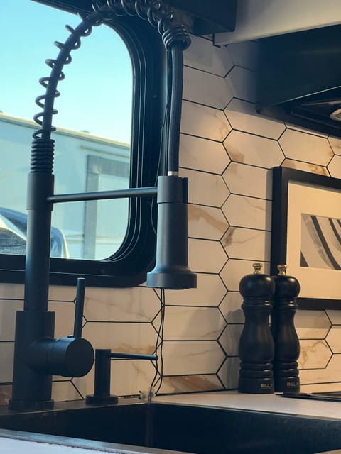 Custom kitchen with industrial pulldown faucet, built in dish soap dispenser with organic soap, beautiful decor and fully stocked with everything!