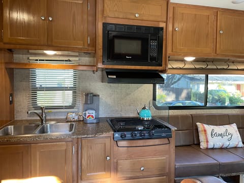 The kitchen features a dual sink, 3 burner range, and a refrigerator. We also provide a Keurig coffee maker, a toaster, a tea pot and a crockpot.
