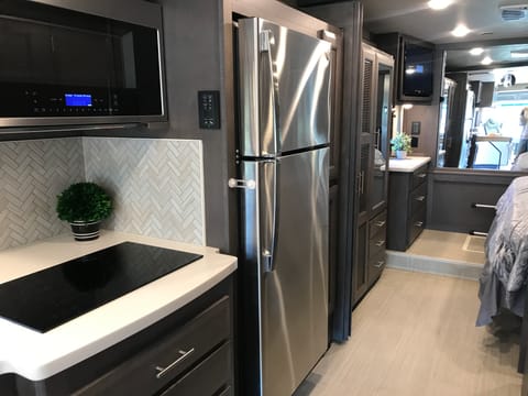Closer view of the fridge + glimpse of your master suite with king size bed