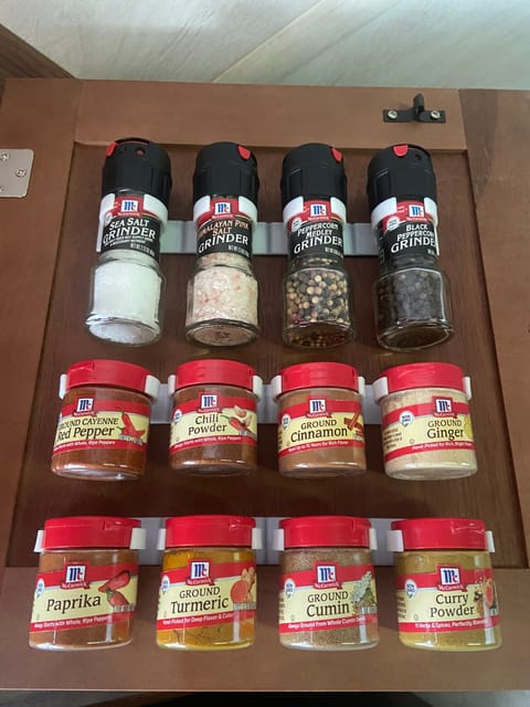 Spices stocked in upper kitchen cabinet. 