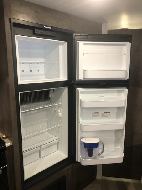 Freezer and fridge that includes a water filter jug