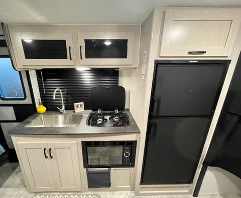 Your Adventure Kitchen comes equipped with:
* Large stainless steel sink
* Multi Burner Cooktop
* Microwave
* Large Refrigerator 
* Ample Storage