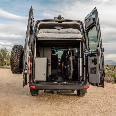 The queen bed rises on hydraulics to fit 2 full size mountain bikes in Rocky Mounts racks. Racks can be removed for more storage.