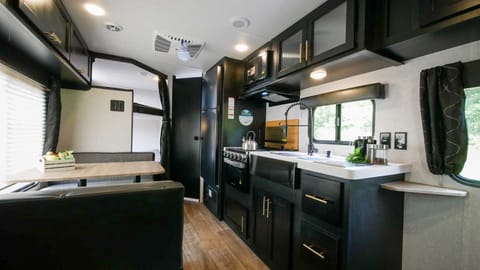 Full size refrigerator cools while driving down the road, three burner stove top, oven microwave and large sink.