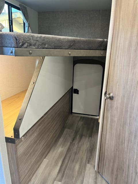 The bottom bunk pulls up to allow for extra storage.