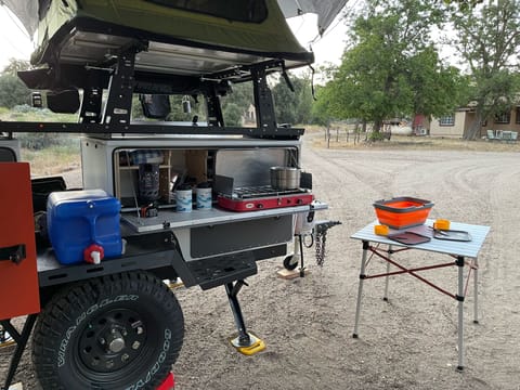 Penny's stainless steel countertop, stove, dishware, sinks, and exterior table work well to provide the ultimate campsite kitchen. 