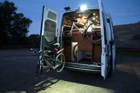 Rear showing bike storage area, (one on the bike maintenance arm.)  Also shows the rear overhead work light, wheel storage and open storage.