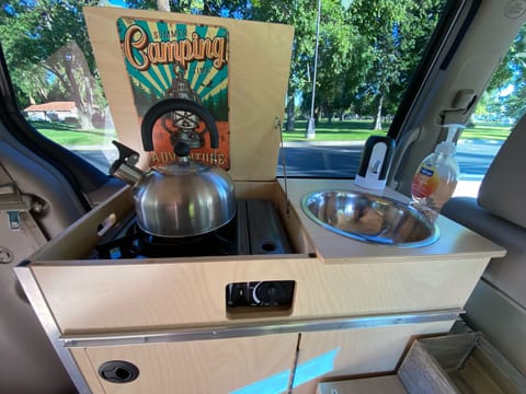 stove and sink with 5 gallons of fresh water