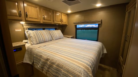 The master bedroom has a walk-around bed and plush mattress for comfort as well as plenty of storage.