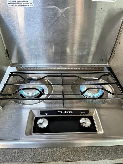 Two burner, natural gas stove top. Turn on gas, and light with the provided lighter. 