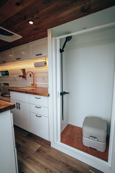 The Mammoth from Scenic Vans comes with a full shower - 24" by 36".  It has a Nautilus Shower Door that is self cleaning.  To use the shower, removed the toilet and the holding plate.