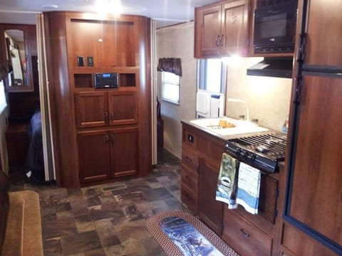 Open living and kitchen area.  32" TV with remote included.