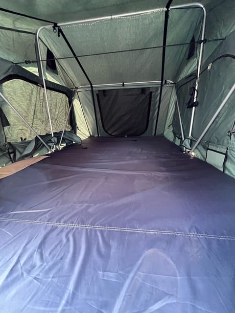 showing the queen-sized camp mattress in the rooftop tent.