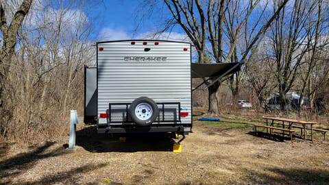 Back of camper w/ bike rack and spare tire.