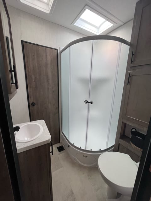 Full size shower. Has 2 bathroom doors that lead to bedroom and main area