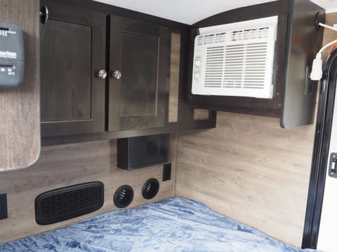 At the food of the bed you'll find several cupboards, a great speaker system for the built-in stereo, and heater / A/C unit.