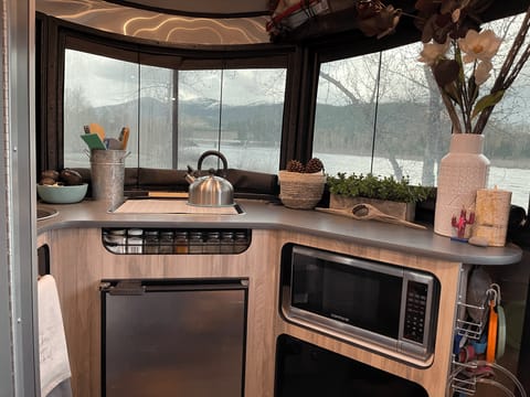 Great counter space for cooking, with a stove, fridge, microwave and sink (not shown to the left). And these panoramic windows are the best part! 