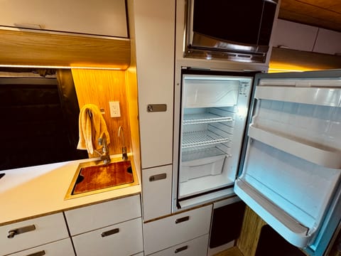 Kitchen with induction stovetop and stocked with cooking essentials