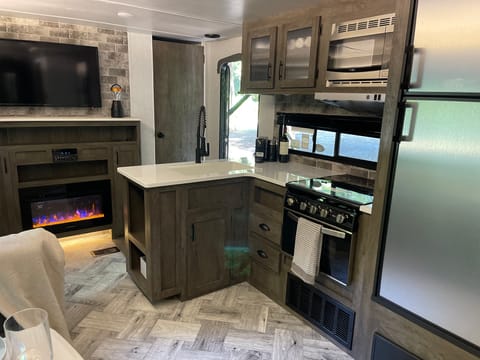 Kitchen with large sink, gas stove and oven, fridge, and freezer. 