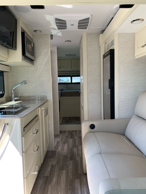 overview of floor plan of this modern and fully loaded coach. Lounge area also has a slide out which expend the living area of this coach