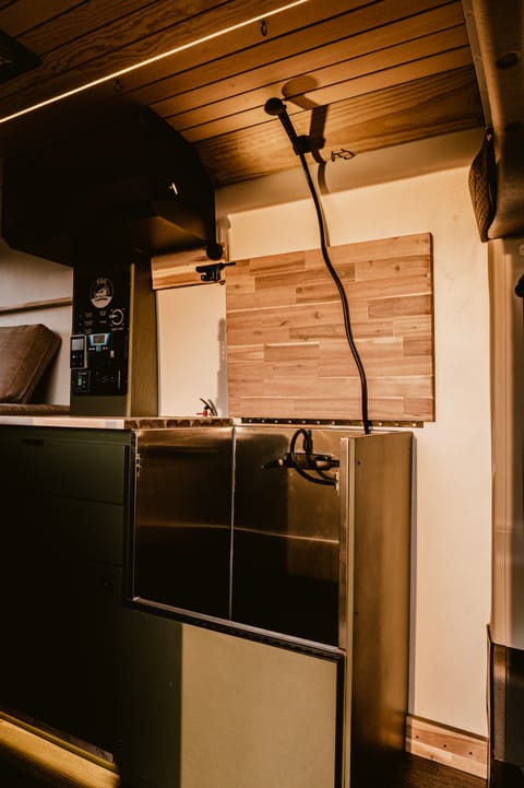 Indulge in the luxury of a compact yet efficient indoor shower within our camper van, where clever design ensures a refreshing bathing experience without compromising valuable space.