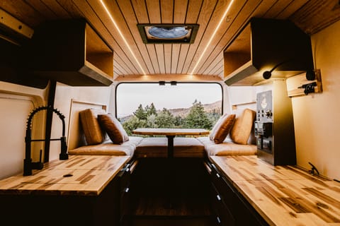 Immerse yourself in the luxury of simplicity within our camper van's interior, where clean lines, natural materials, and smart design converge to create a space that feels like home wherever the road takes you.