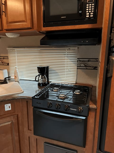 Stove, microwave, Refrigerator and coffee maker, toaster.