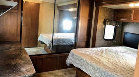 Queen size bed with overhead storage & nightstands as well as a full size closet and desk with storage. 