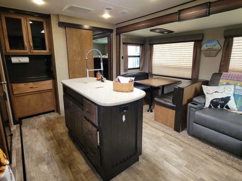 Kitchen with island, dining table and lounge area.