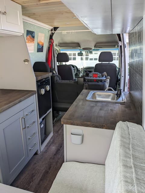 butcher block countertops, sink, and lots of storage