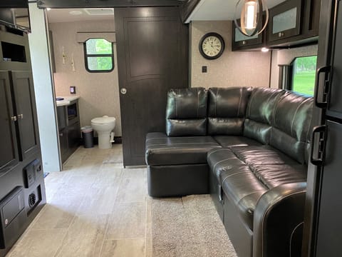 This couch, which turns into an almost full size bed, is as cozy as it is spacious. The extra large bathroom is located at the end of the camper.