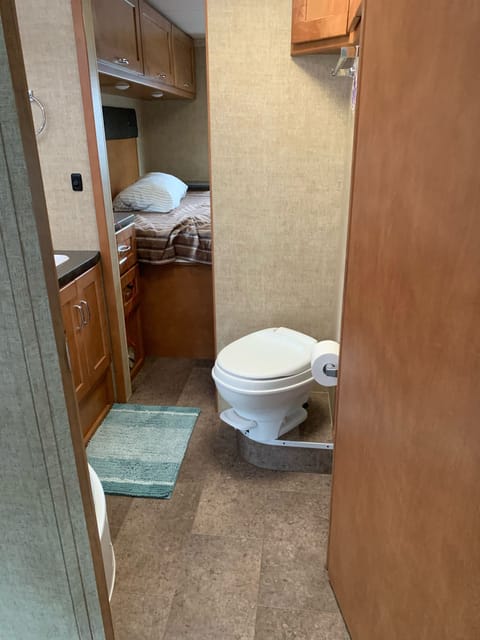 Roomy with shower, sinks, cabinets for storage.  Vanity and mirror.