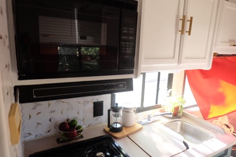 Full kitchen with 3 gas burners, oven, refrigerator, freezer and microwave