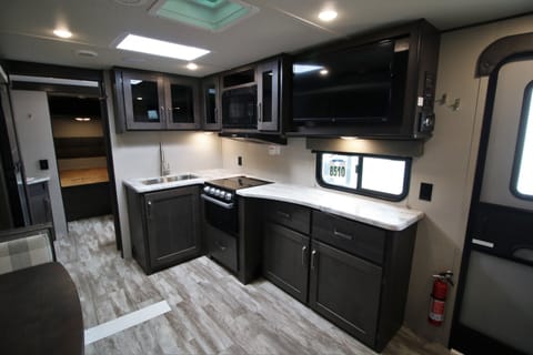 Oven, microwave, TV, sink and cabinets 
