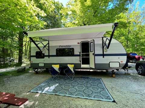 Setup ready for camping. Camping chairs, mat, and awning included!