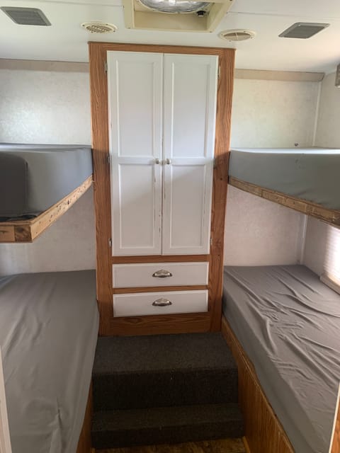 Four back bunks and large storage area in the back and two more cupboards at the feet of each bed.