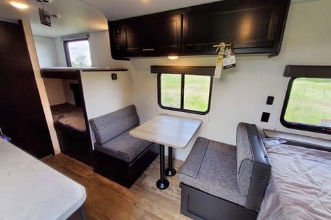 Interior image showing booth dinette and single bunks