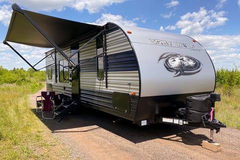 Exterior image of 2022 Forest River Grey Wolf travel trailer with awning