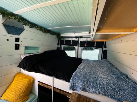 Bed is a couple of inches shy of a full mattress. There is a wall shelf for easy sleep reach. Light dimmer and USB outlets are under the mirror.