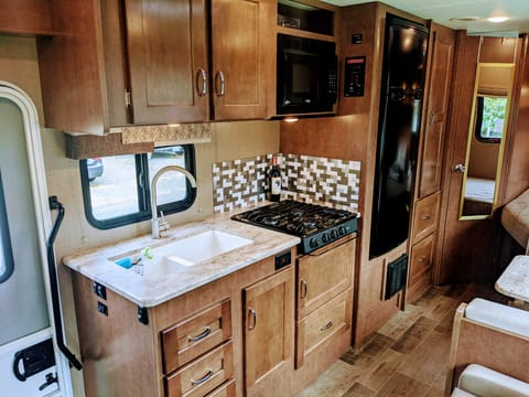 Good size fridge, double sink, & 3 burner stove