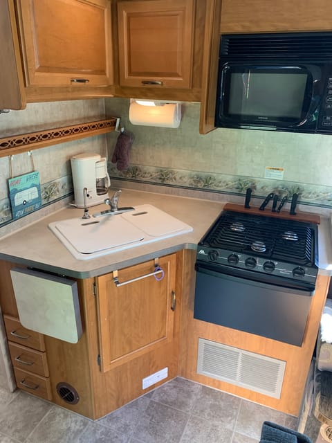 Microwave, stove, oven, sink, extended counter, coffee maker, and filtered water for drinking!