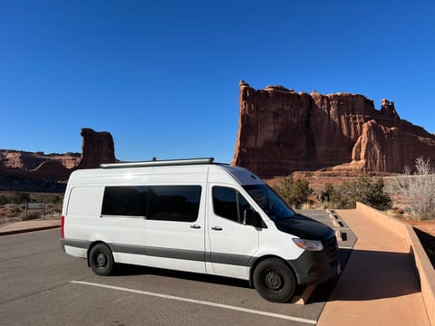 Total camper van length at 23', fits most standard parking spots. Photo at our favorite national park, Arches!