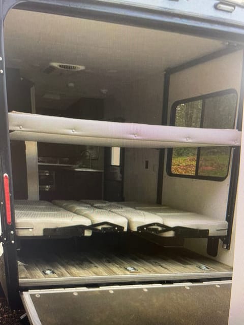 Ramp dropped with pull down screen down so you can enjoy the scenery while relaxing inside the trailer . Lower Queen been converts into two couches 