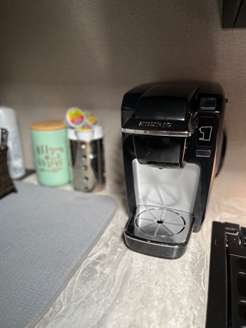 Coffee maker, variety of k-cups, creamer and sugar provided.