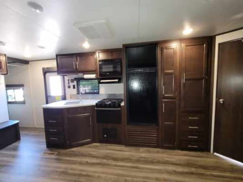 Fully stocked kitchen with double sink, microwave, 3 burner gas cooktop, oven, refrigerator, freezer and large pantry. Large wardrobe space.