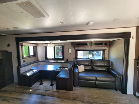 Large u-shaped dinette, tri-fold couch and extra storage.