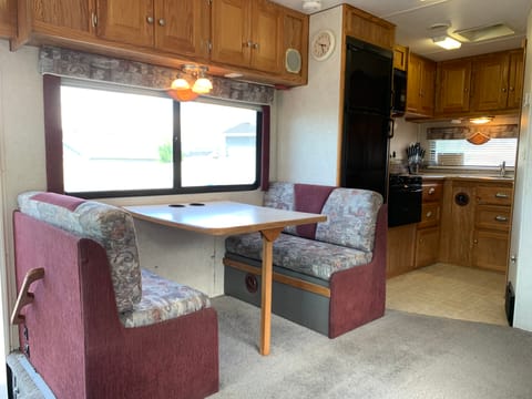 Dinette fits four comfortably! Storage and a view of the kitchen as well. Dinette converts to a twin sized bed.