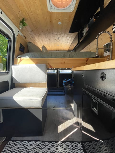 Spacious garage will let you take anything you need for your adventure. There is additional storage located under this grey kitchen seat as well.